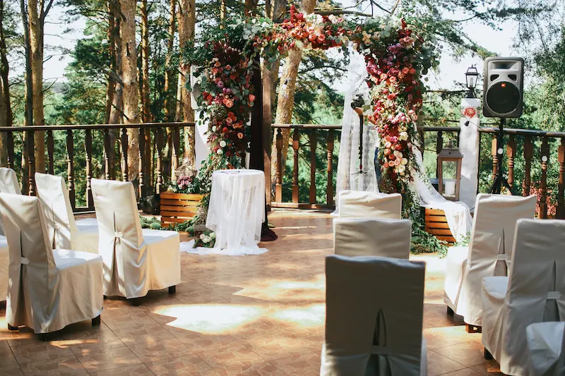 white-chairs-stand-before-wedding-altar-porch Backyard Small Weddings
